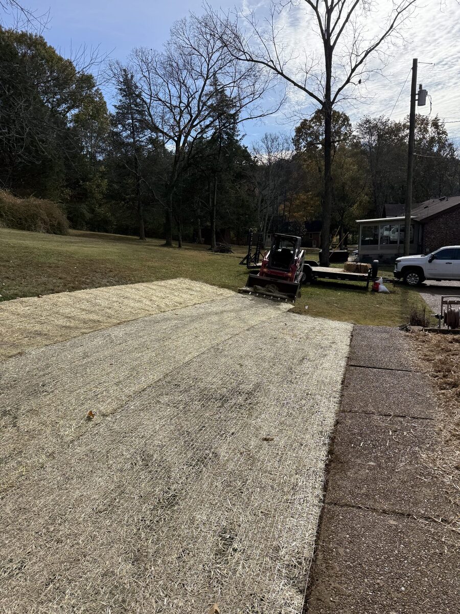 Completed seed and straw erosion control with equipment on site