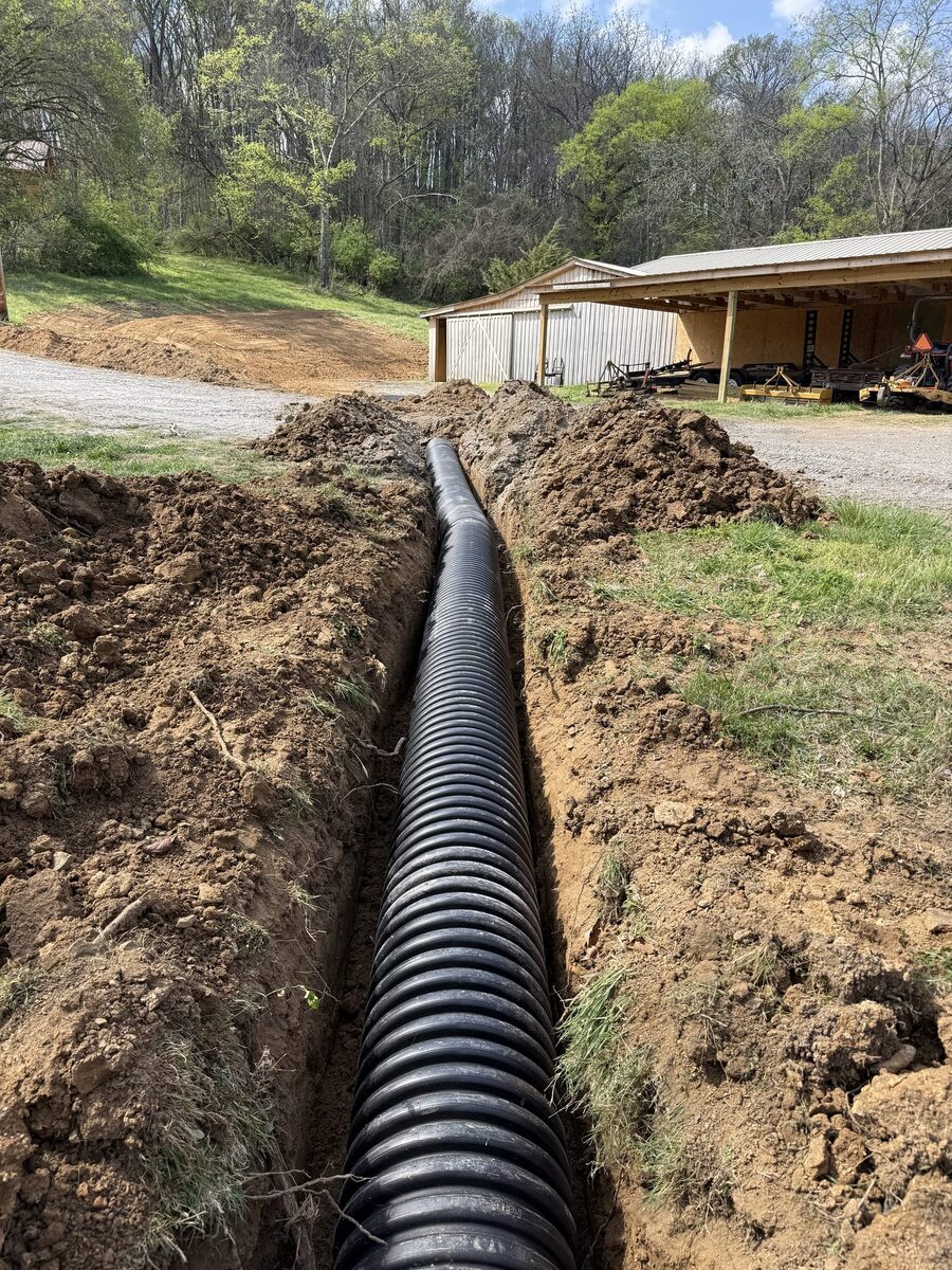 Large corrugated drainage pipe installation in trench