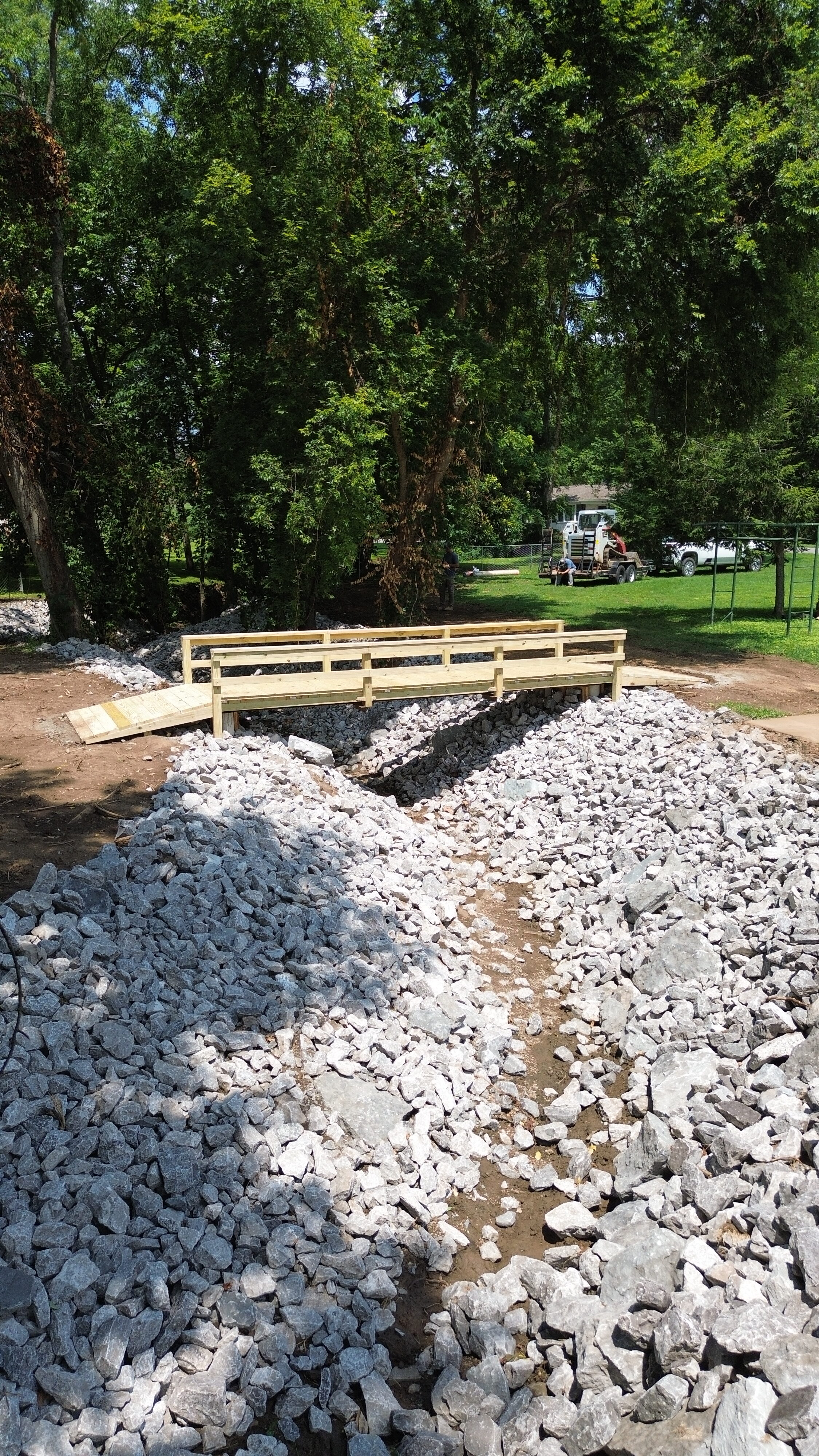 Aerial view of completed riprap drainage channel and wooden bridge — Nashville TN