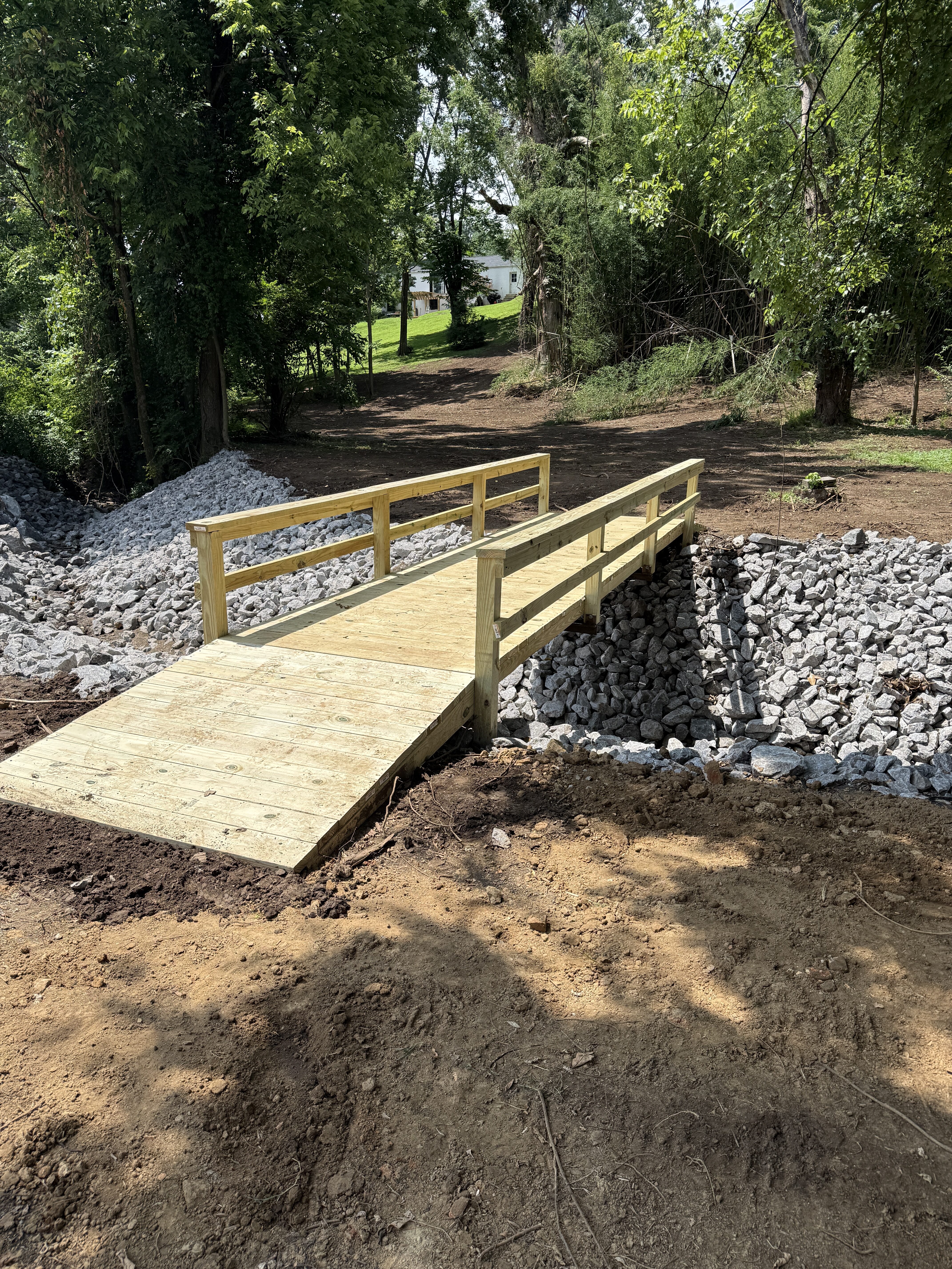 Pressure-treated bridge over riprap drainage channel — Nashville TN