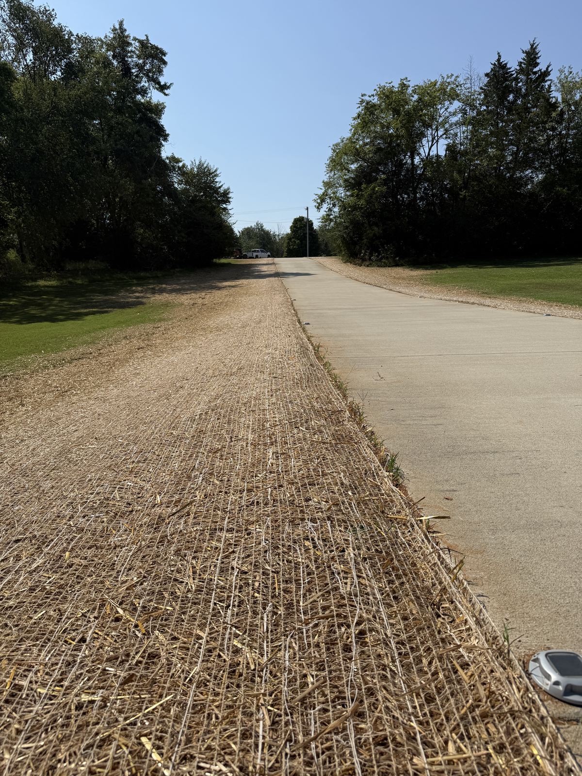 Driveway edge graded flush with topsoil, seeded and covered in BioNet erosion matting &mdash; Greenbrier TN