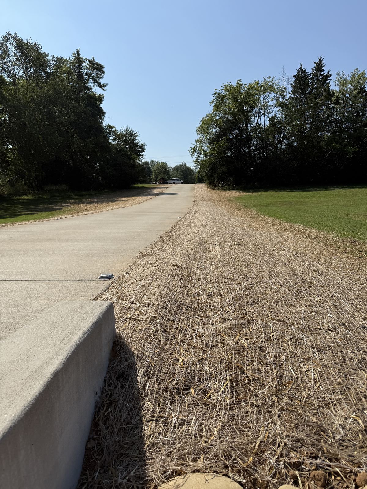 Erosion control blanket installed along the full length of a new concrete driveway &mdash; Greenbrier TN