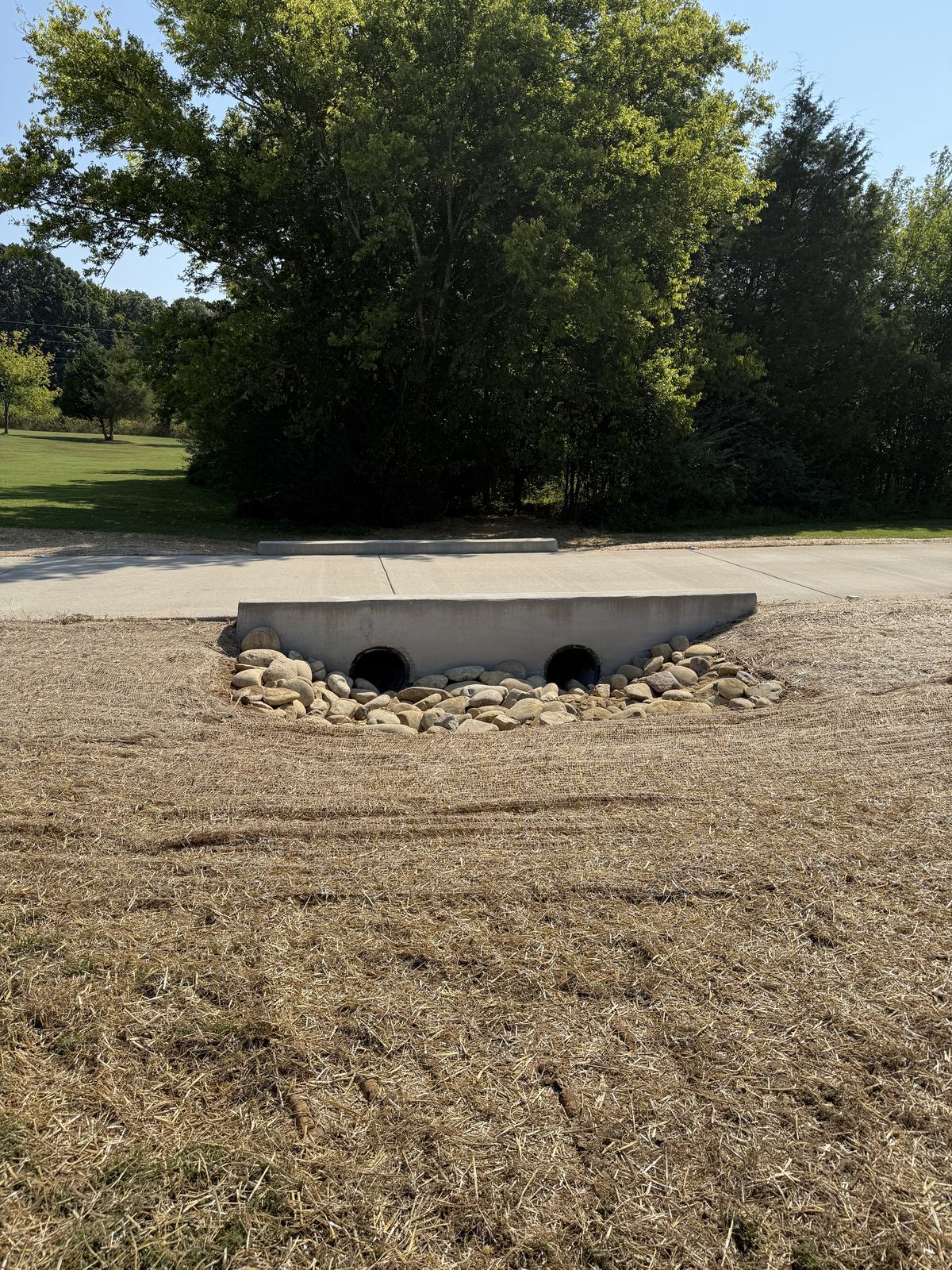 Second crossover pipe outlet finished with Pigeon River rock and seeded, strawed ditch &mdash; Greenbrier TN