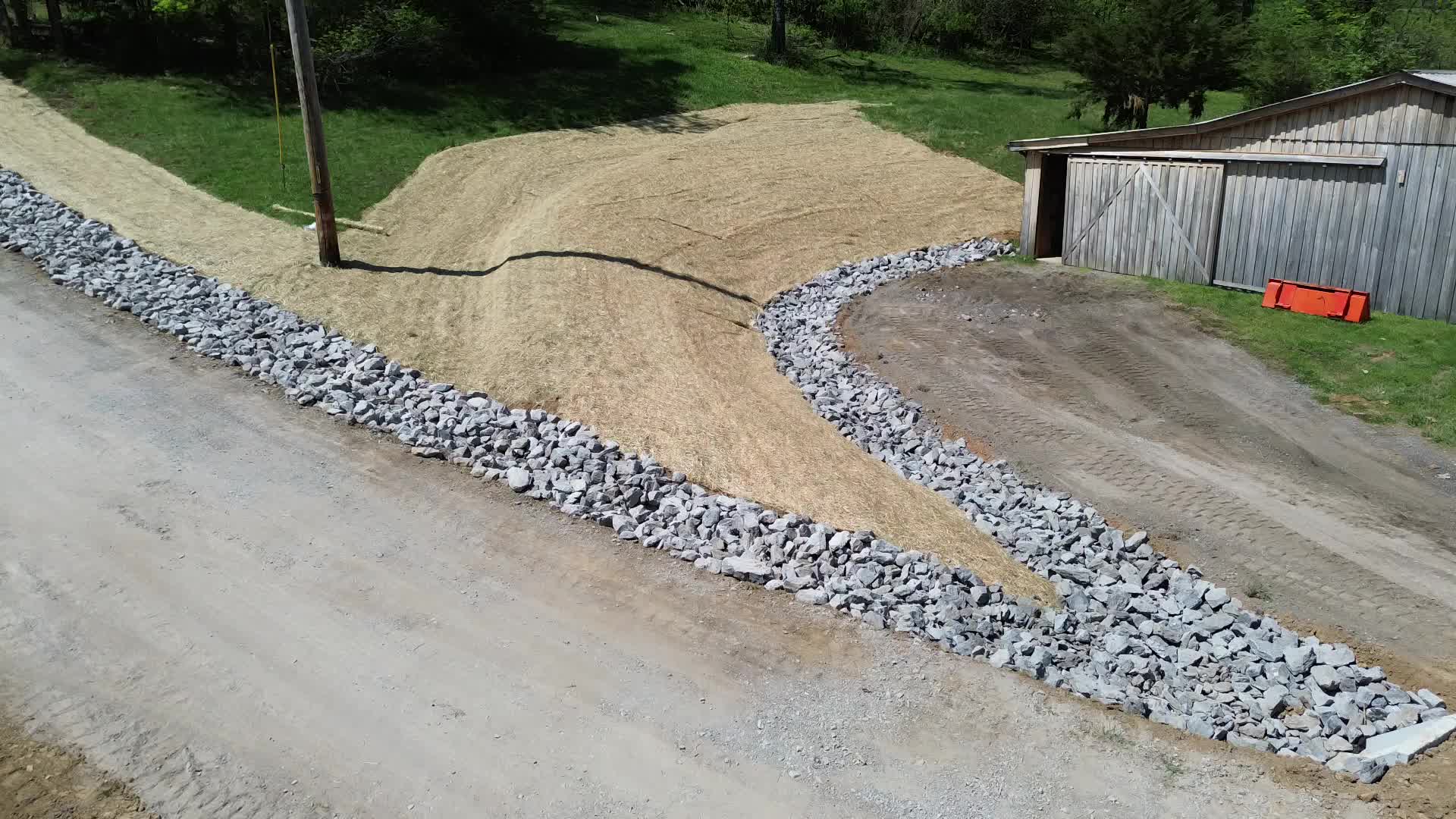 Aerial — riprap swale alongside completed driveway