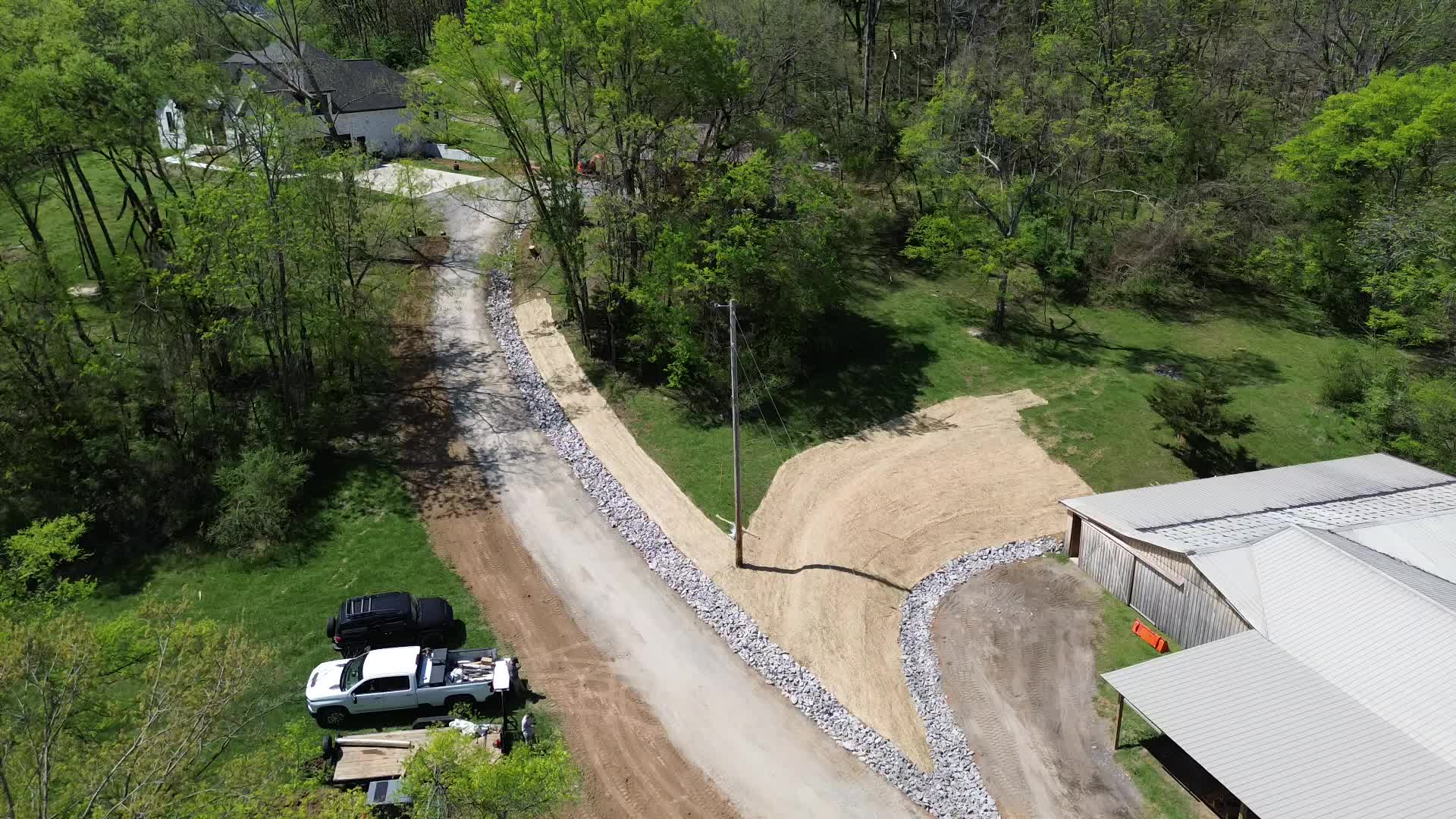 Bird's eye aerial — full project scope, driveway and drainage