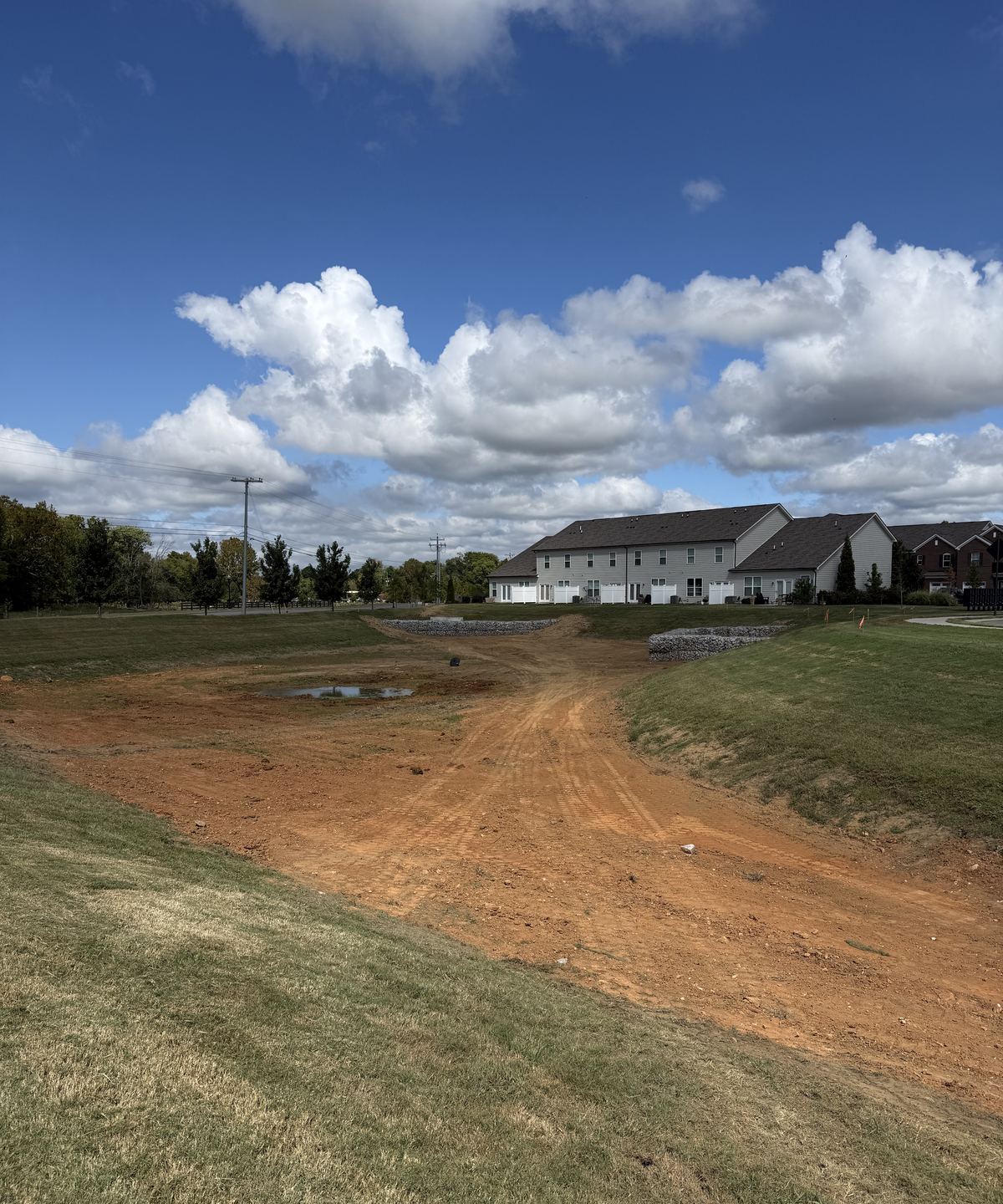 Rebuilt red dirt pond bottom with gabion forebays at the far inlets and seeded banks &mdash; Lebanon TN