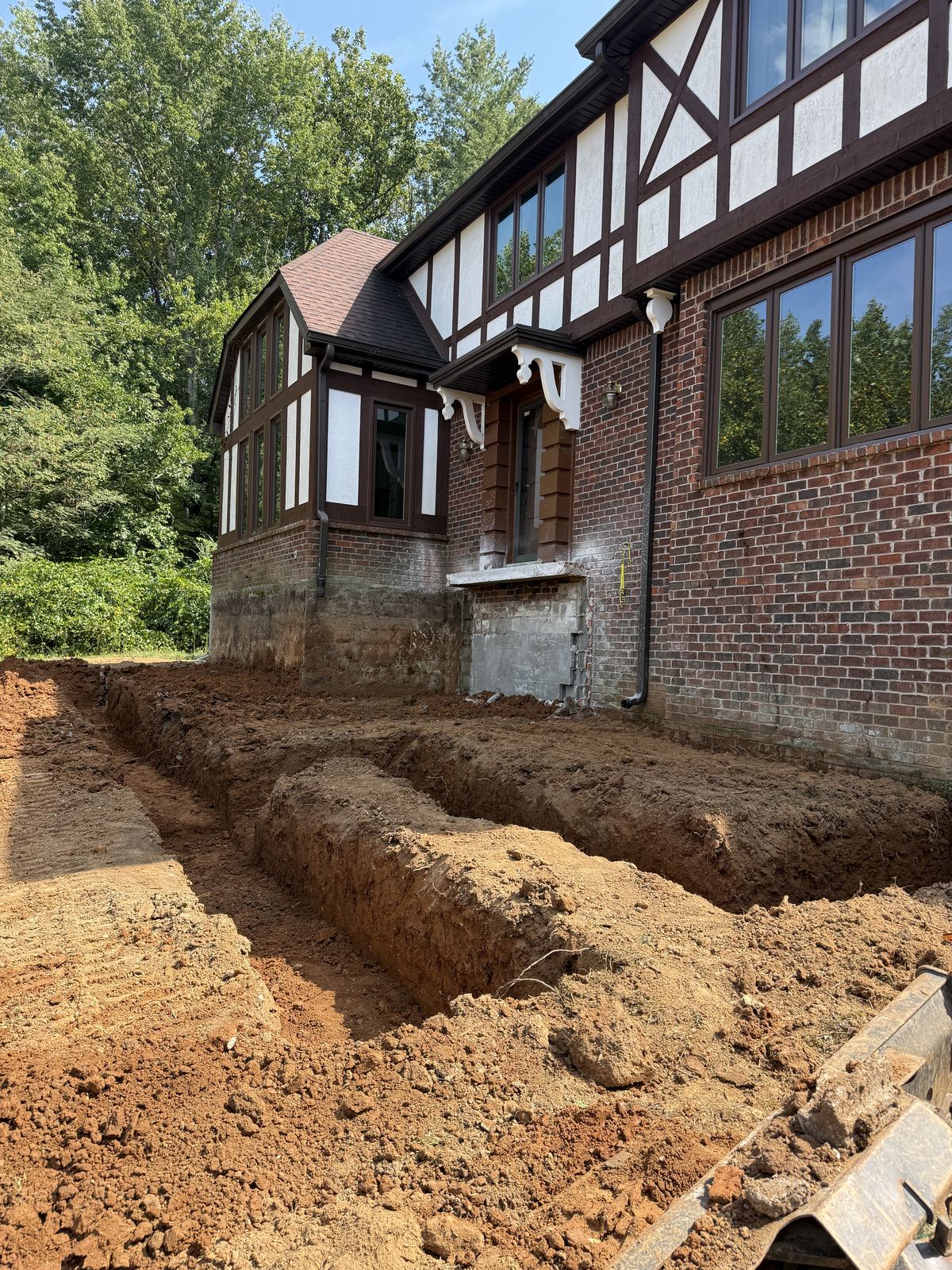 Footer trenches excavated along the house for a new porch build &mdash; Hendersonville TN