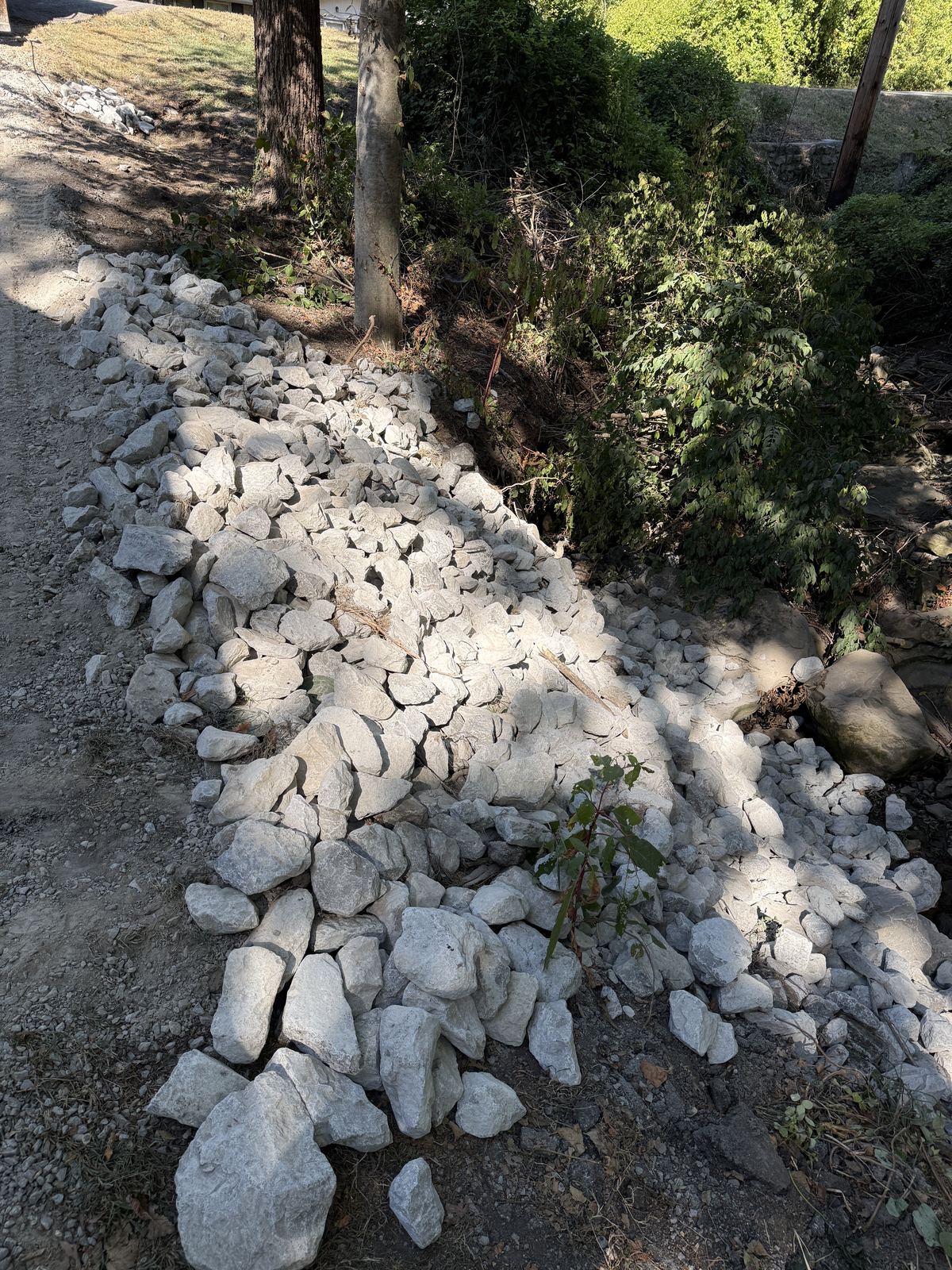 Riprap along the edge of a gravel driveway where the creek bank had washed out &mdash; Nashville TN, after