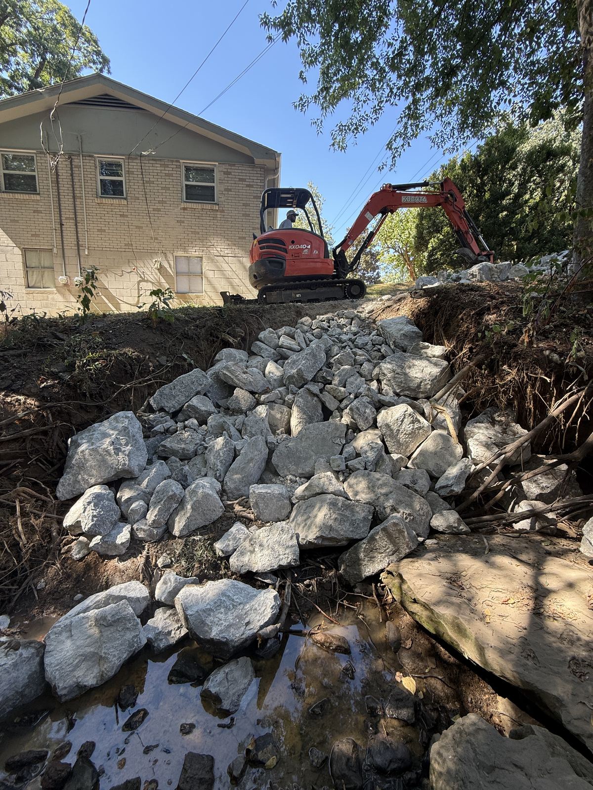 Class B riprap set from the creek up the bank toward the driveway with a Kubota mini excavator &mdash; Nashville TN