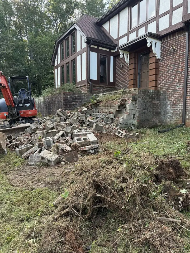 Brick porch broken out with mini excavator, debris staged for haul off — Hendersonville TN